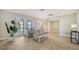 Cozy living room with comfortable seating, neutral colors, and natural light from the large windows at 4409 Eleuthera Ct, Sarasota, FL 34233