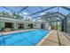 Large screened-in pool with patio, lounge chairs, and clear blue water at 4409 Eleuthera Ct, Sarasota, FL 34233