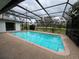 Inviting screened-in pool with a view of the lush green backyard at 4409 Eleuthera Ct, Sarasota, FL 34233