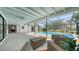 Beautiful screened-in pool area with covered seating at 4409 Eleuthera Ct, Sarasota, FL 34233