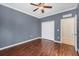 Bedroom with gray walls, wood-look floors, white closet doors and ceiling fan at 4518 62Nd E Ter, Bradenton, FL 34203