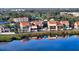 Waterfront condo featuring impact windows, tile roof, and serene water views from multiple stories at 4557 Bay Club Dr, Bradenton, FL 34210