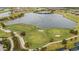 Aerial view of a luxury golf community with a lake and lush landscaping at 4727 Motta Ct, Bradenton, FL 34211