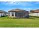 Backyard with screened lanai, perfect for outdoor dining and relaxation at 4727 Motta Ct, Bradenton, FL 34211