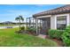 Backyard featuring a screened-in lanai overlooking a tranquil canal at 4727 Motta Ct, Bradenton, FL 34211