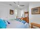 Bedroom with wooden dresser and bed, featuring blue and gray bedding at 4727 Motta Ct, Bradenton, FL 34211