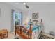 Bright bedroom with wooden bed frame and blue bedding, featuring a large window at 4727 Motta Ct, Bradenton, FL 34211
