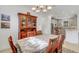 Open dining room with view into kitchen, and a wood table with seating for six at 4727 Motta Ct, Bradenton, FL 34211