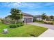 Exterior view showcasing a house with a gray garage door and well-manicured lawn at 4727 Motta Ct, Bradenton, FL 34211