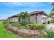 Exterior of house with gray garage door, walkway, and lush landscaping at 4727 Motta Ct, Bradenton, FL 34211