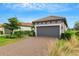 House exterior showcasing a gray garage door and a nicely landscaped front yard at 4727 Motta Ct, Bradenton, FL 34211