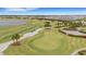 Golf course with putting green and players at 4727 Motta Ct, Bradenton, FL 34211