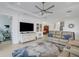 Open living space with a large TV, ample seating, and views into a bedroom at 4727 Motta Ct, Bradenton, FL 34211