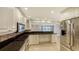 Modern kitchen with stainless steel appliances and breakfast bar at 4825 Gulf Of Mexico Dr # 303, Longboat Key, FL 34228