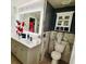 Bathroom featuring marble tile, white vanity, modern fixtures, and backlit mirror at 5026 Brickwood Rise Dr, Wimauma, FL 33598