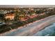 Luxury beachfront home with private walkway at dusk at 507 Casey Key Rd, Nokomis, FL 34275