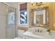 Elegant bathroom with marble vanity, frame mirror, and a shower stall at 507 Casey Key Rd, Nokomis, FL 34275