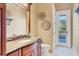 Powder room with granite vanity and private balcony access at 507 Casey Key Rd, Nokomis, FL 34275