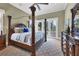 Main bedroom with a large four poster bed and French doors at 507 Casey Key Rd, Nokomis, FL 34275