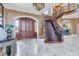 Elegant entryway with double doors and a grand staircase at 507 Casey Key Rd, Nokomis, FL 34275