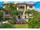 Mediterranean home with palm trees and landscaping at 507 Casey Key Rd, Nokomis, FL 34275