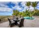 Ocean view patio with seating for four at 507 Casey Key Rd, Nokomis, FL 34275