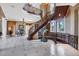 Large, curved staircase with ornate railing at 507 Casey Key Rd, Nokomis, FL 34275