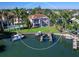 Waterfront home with dock and boat, enclosed patio, backyard, and red-tiled roof at 508 Siesta Dr, Sarasota, FL 34242