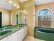 Bathroom with a green marble bathtub and double vanity at 508 Siesta Dr, Sarasota, FL 34242