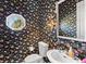 Small bathroom with floral wallpaper and white sink at 508 Siesta Dr, Sarasota, FL 34242