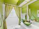 Green bathroom with glass sink, shower, and striped curtains at 508 Siesta Dr, Sarasota, FL 34242