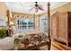 Cozy bedroom featuring a four-poster bed, sliding glass door to the outdoors, and water views at 508 Siesta Dr, Sarasota, FL 34242