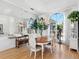 Bright dining room with hardwood floors, large windows, and a lovely chandelier at 508 Siesta Dr, Sarasota, FL 34242