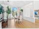 Bright dining room features wood floors and a large arched window overlooking the yard at 508 Siesta Dr, Sarasota, FL 34242