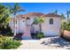 Two-story home with terracotta roof, pink exterior, and a grand staircase at 508 Siesta Dr, Sarasota, FL 34242