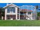 Back of house showing large windows, screened enclosure and pool at 508 Siesta Dr, Sarasota, FL 34242