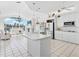 Open-concept kitchen with white cabinetry and appliances, with views to the living area and yard at 508 Siesta Dr, Sarasota, FL 34242