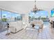 Light-filled living room with tile flooring and a large arched window providing water views at 508 Siesta Dr, Sarasota, FL 34242