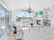 Bright living room with water views, fireplace, and chandelier at 508 Siesta Dr, Sarasota, FL 34242