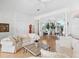 Spacious living room boasts neutral tones, wood floors, and access to the dining area at 508 Siesta Dr, Sarasota, FL 34242