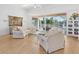 Bright living room with hardwood floors, comfy sofas, and access to a balcony at 508 Siesta Dr, Sarasota, FL 34242