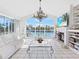Relaxing living room with white sofas, a fireplace, and water views at 508 Siesta Dr, Sarasota, FL 34242