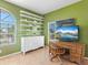 Bright office space features a desk, chair, shelving and a window with natural light at 508 Siesta Dr, Sarasota, FL 34242