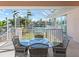 Screened-in patio boasts a dining table and view of the canal at 508 Siesta Dr, Sarasota, FL 34242