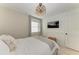 Bedroom with a gray upholstered bed, TV and white wainscoting at 522 Pine Ave # 6D, Anna Maria, FL 34216