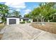 Updated home exterior with a modern gray garage door and landscaping at 525 Hillside S Dr, St Petersburg, FL 33705