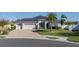 Single-story home with two-car garage, palm trees, and a brick driveway at 5514 72Nd E Ter, Ellenton, FL 34222