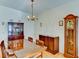 Bright dining room with wood table and chairs, and a grandfather clock at 5604 Garden Lakes Dr, Bradenton, FL 34203