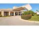 Elegant community clubhouse with covered entryway and landscaping at 5862 Guarino Dr, Sarasota, FL 34238