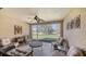 Relaxing screened porch with wicker furniture and view of the backyard at 5862 Guarino Dr, Sarasota, FL 34238